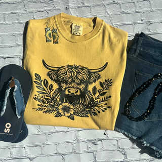 This is the Highland Cow Graphic Tee in the color mustard. The brand is Comfort Colors. 