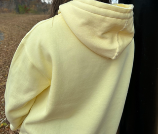 This is a Kelly Classic Pullover Hoodie in the color Butter. It is presenting the back of the hoodie.