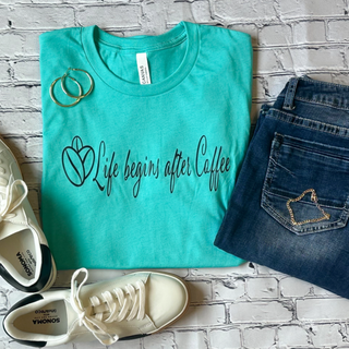 This is the Life Begins After Coffee Graphic Tee in the color sea green. The brand is a Bella Canvas, and it is presented as a flat lay.