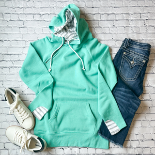 This is the Madi Double Hood Pullover in the color of solid mint. It is presented as a flat lay.